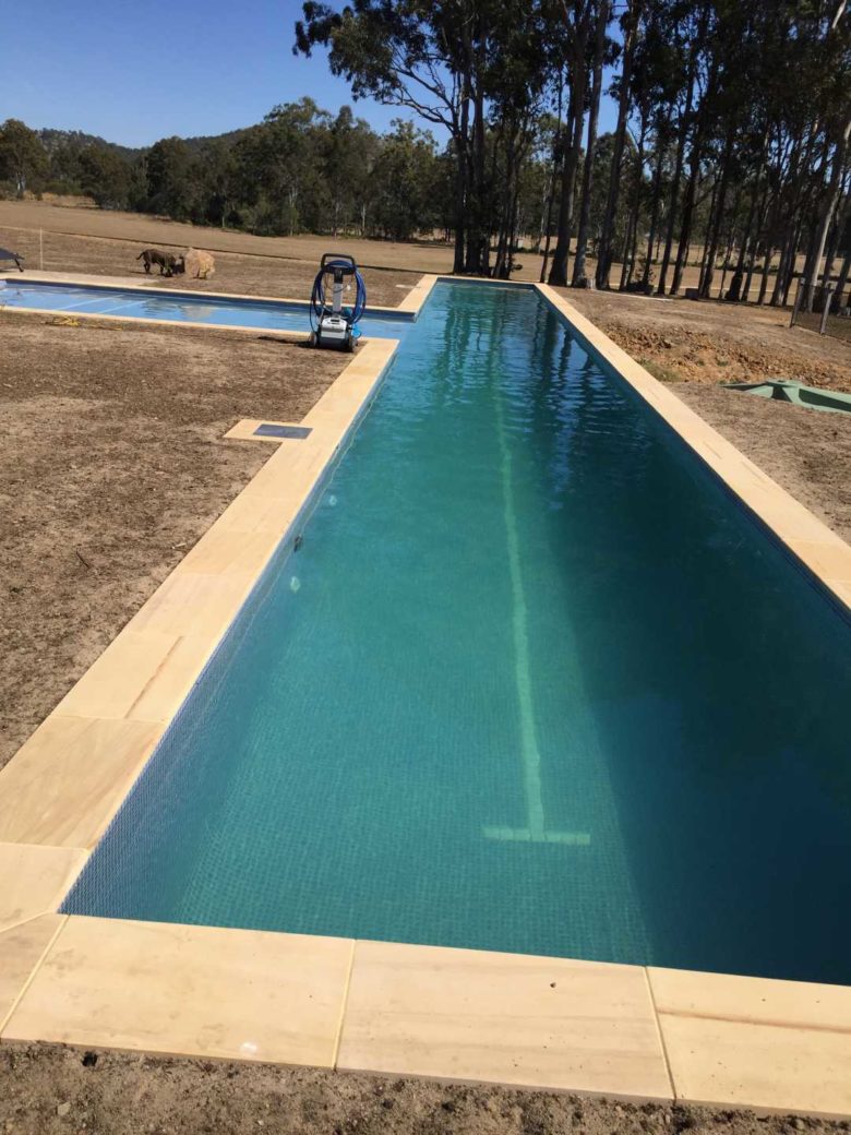 Outdoor 25-metre lap swimming pool with separate toddler pool at Hangar O campground