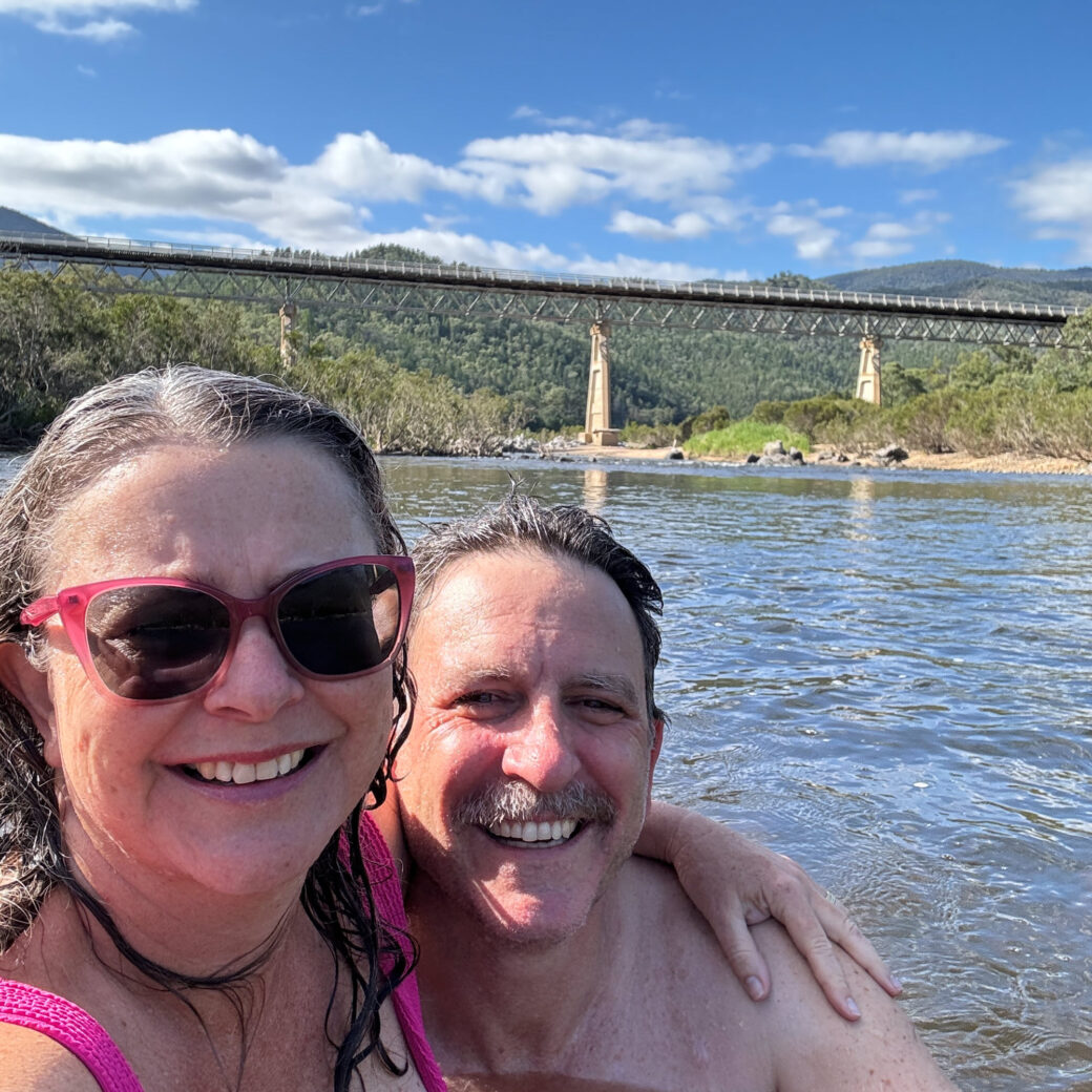 Couple swimming at McKillops Bridge crossing the Snowy River in regional Victoria