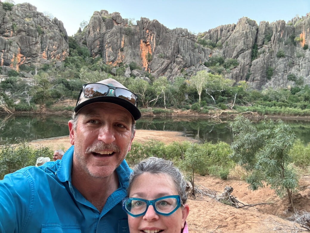 Towering limestone cliffs reflected in calm waters at Windjana Gorge, Gibb River Road