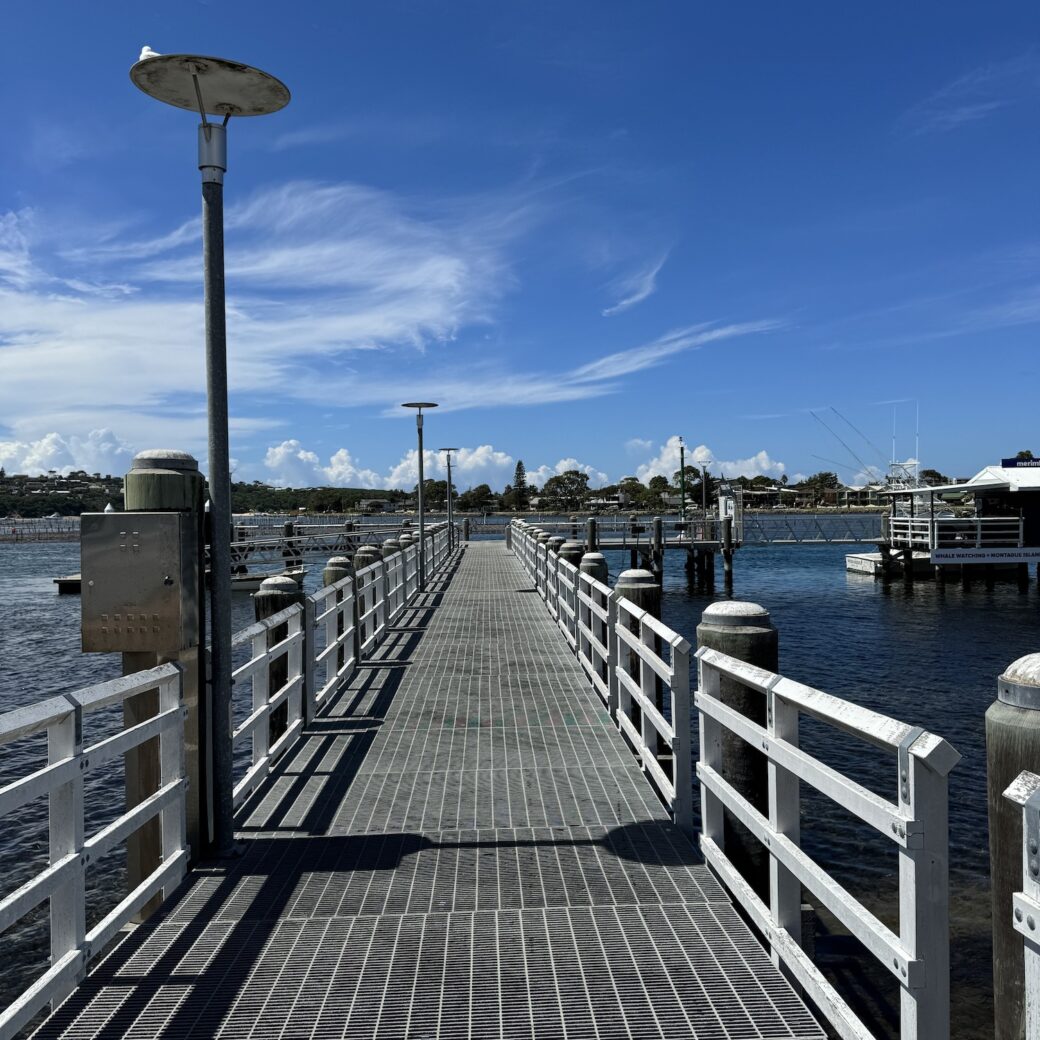 Historic jetty at Market Street Merimbula extending into the bay at sunset