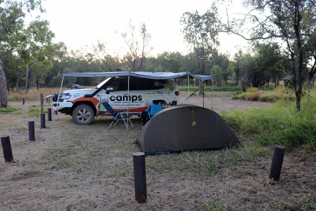 Camper trailer and 4WD parked at Purnululu National Park camping area in Western Australia